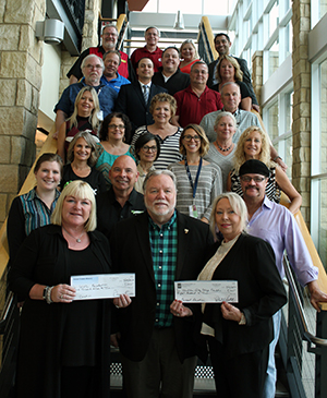 A check for proceeds from the RLS Productions' Concert in the Gardens series is presented to the WVC Foundation