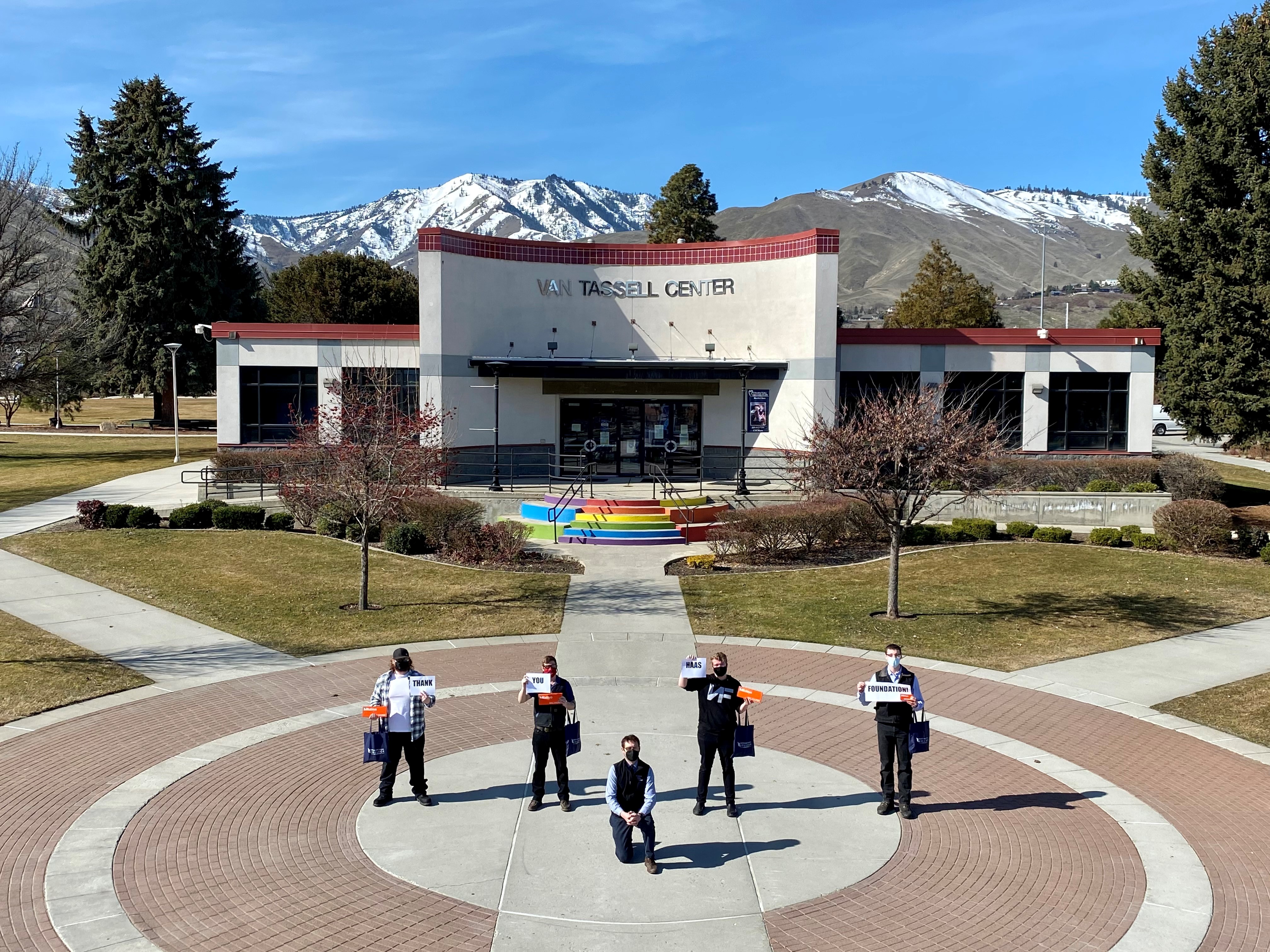 Machining students posing with tools in front of the Van Tassell Center building on the Wenatchee campus
