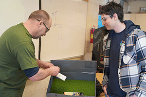 Professor Zack Jacobson works with student Logan Swank on an electronics project.